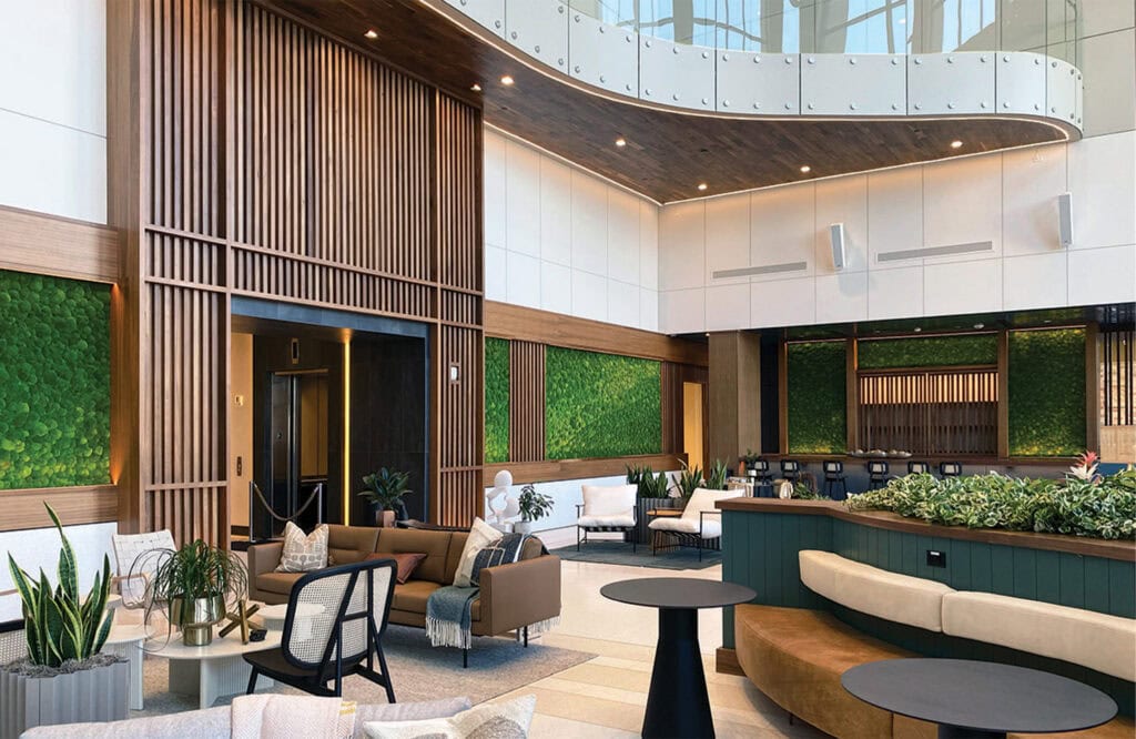 Elegant hotel lobby interior featuring green wall decor and contemporary furniture.