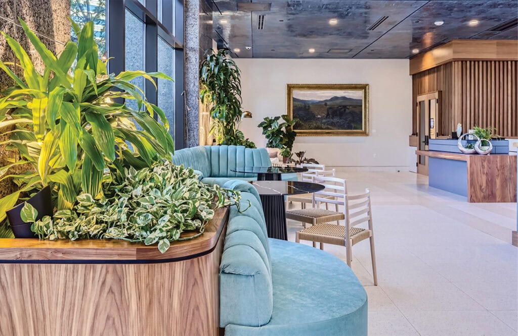 Beautiful hotel lobby featuring modern decor, vibrant green plants, and elegant seating areas.