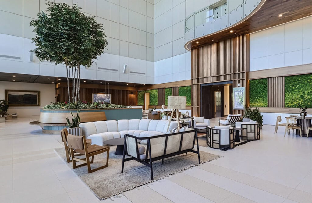 Luxurious hotel lobby featuring modern seating areas, indoor plants, and elegant decor for guest comfort.