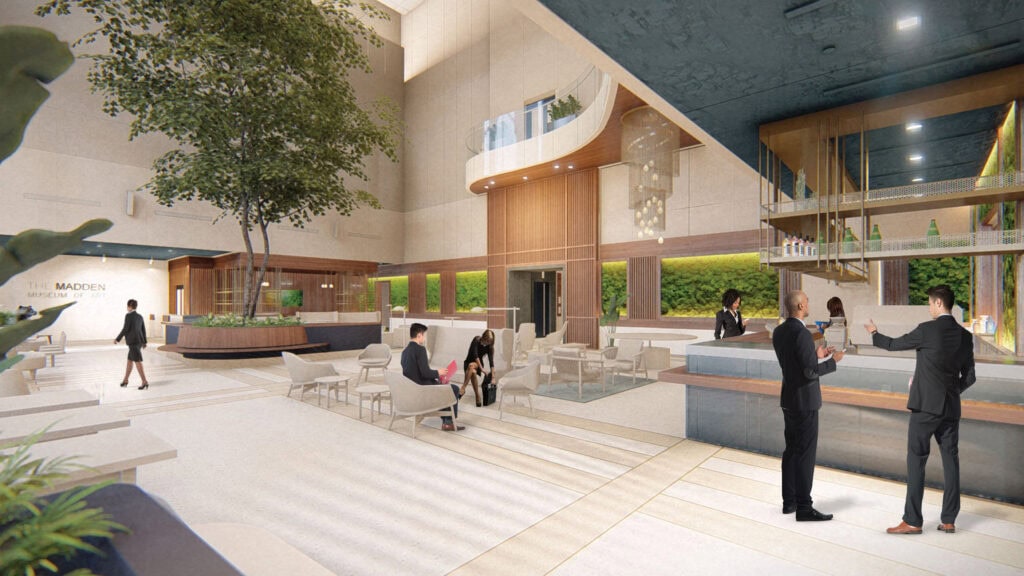 Contemporary building lobby featuring indoor plants, modern furniture, and reception area for events or offices.